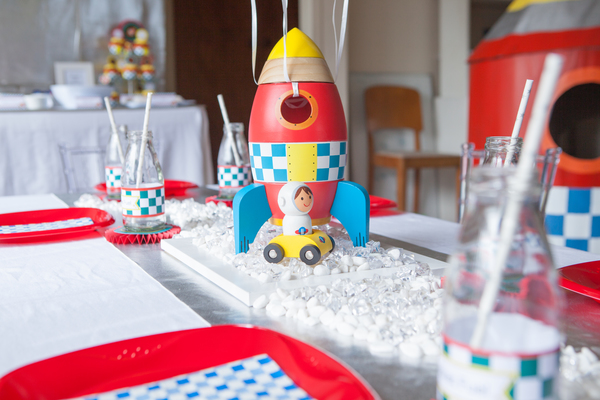 Kids space rocket party table setting and playhouse