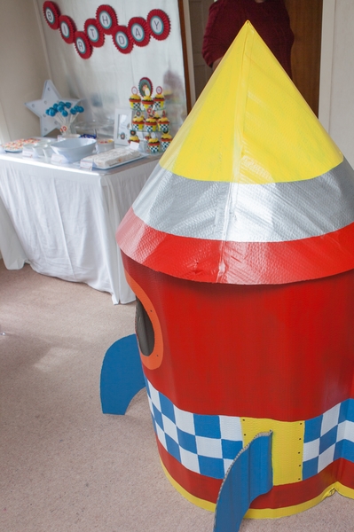 Kids space rocket party playhouse and food table