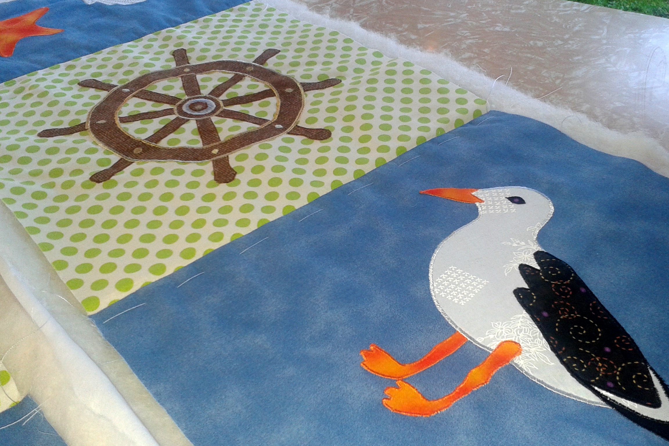 Seagull and Ships Wheel on quilt